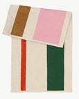 Serviette de plage de la marque Suite 702, couleurs rose vert orange et toffee