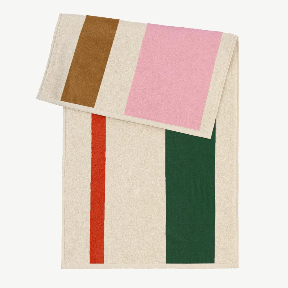 Serviette de plage de la marque Suite 702, couleurs rose vert orange et toffee